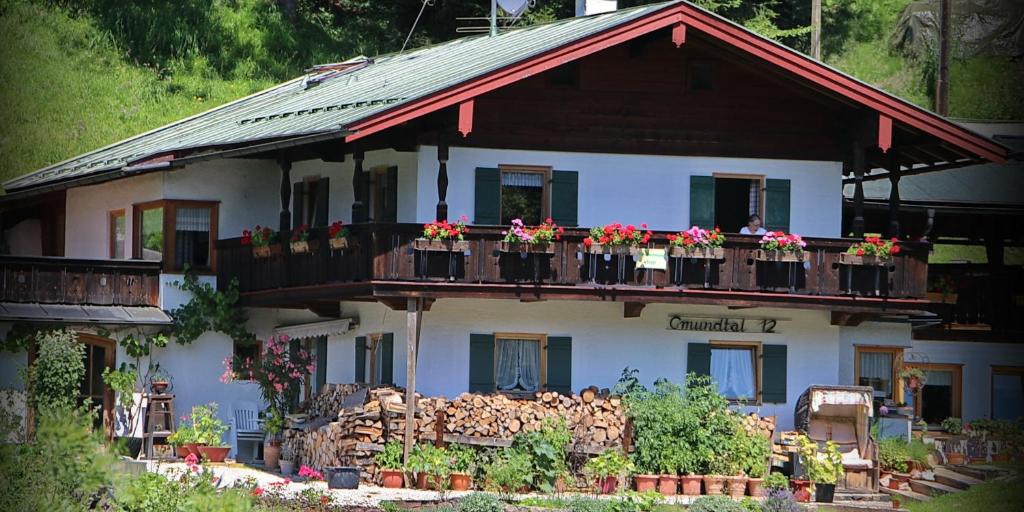 a house with flowers on the balconies of it at Gästehaus Gmundtal in Bischofswiesen