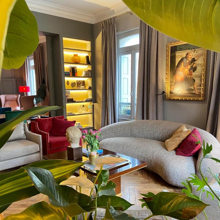 a living room with a couch and a table at VILLA DU CEDRE Honfleur in Honfleur