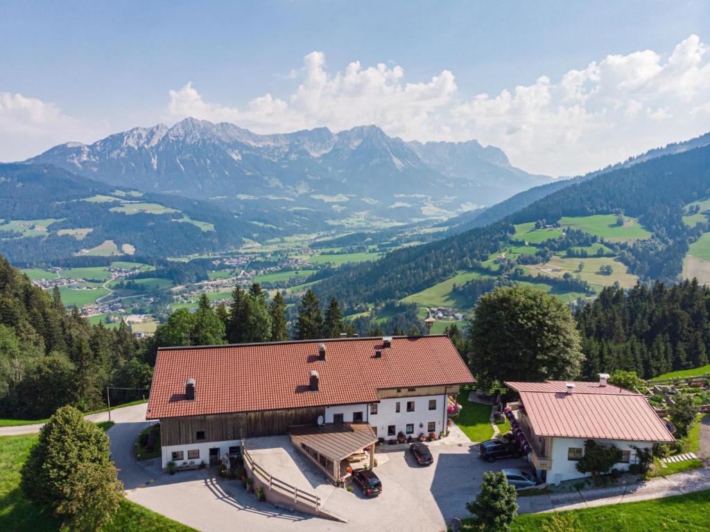 an aerial view of a house with mountains in the background at Koglbauer - Apartment Nr 3 in Söll