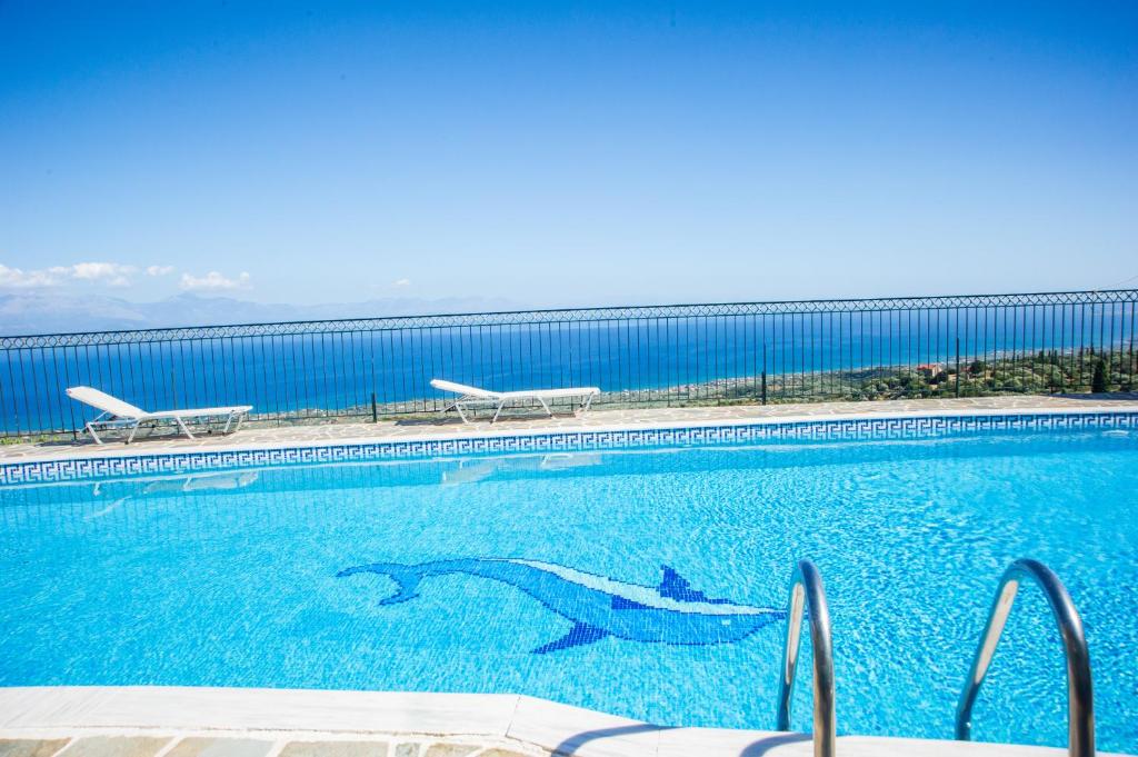 a swimming pool with a shark in the water at Mathia Apartments in Mathía
