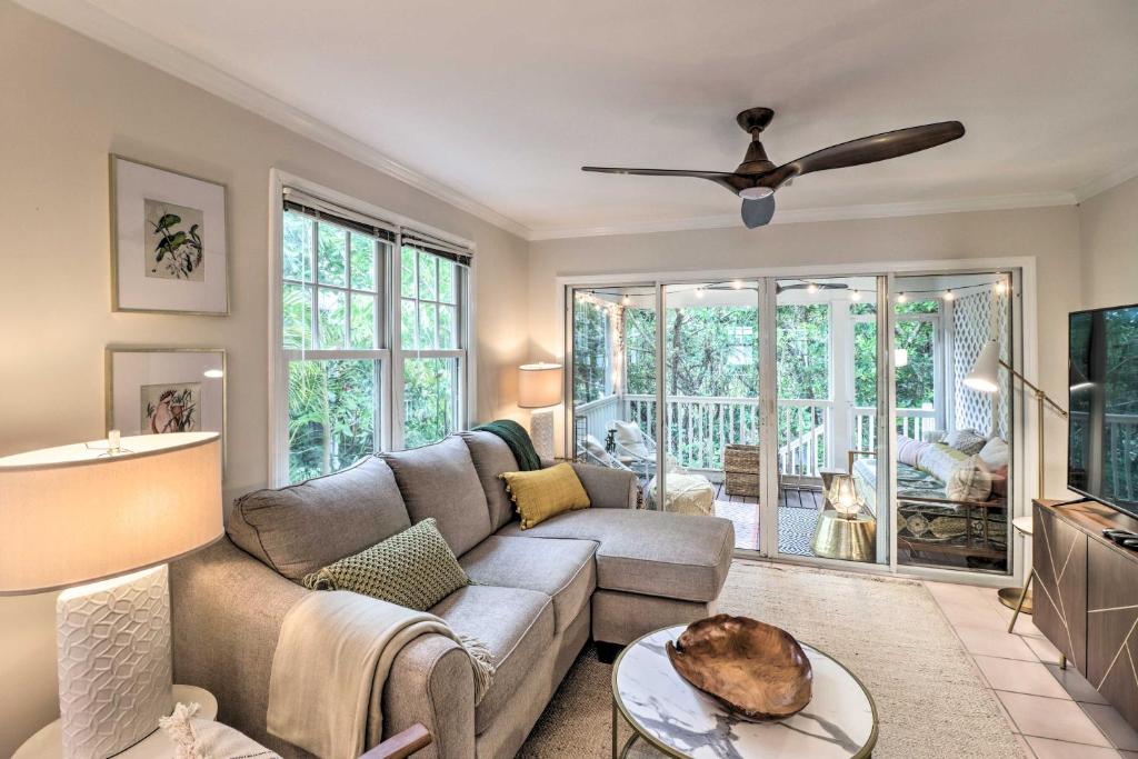 a living room with a couch and a ceiling fan at Charming Boho Breeze Retreat with Pool Access in Key West
