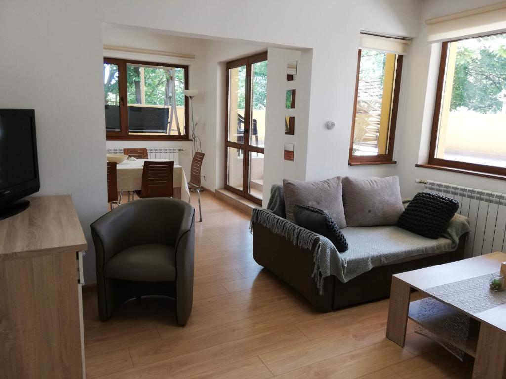 a living room with a couch and a chair at The Yellow House in Stara Zagora