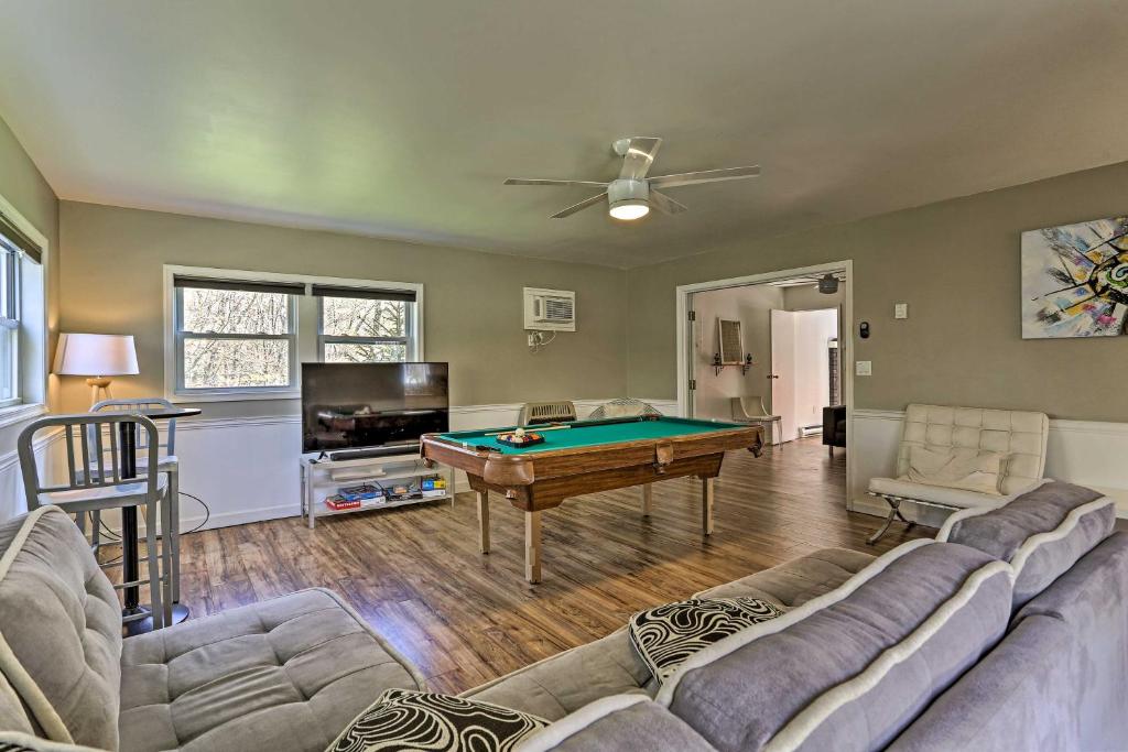 a living room with a couch and a pool table at Peaceful Long Pond Home with Private Hot Tub! in Long Pond