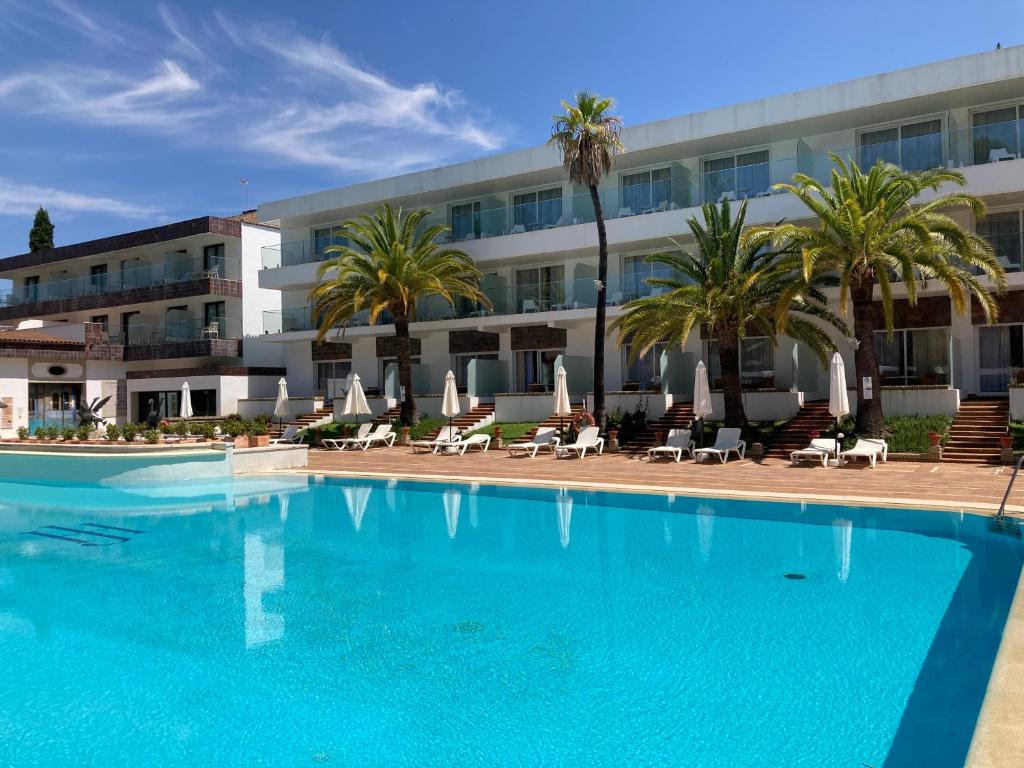 a large swimming pool in front of a hotel at Hotel Jerez & Spa in Jerez de la Frontera