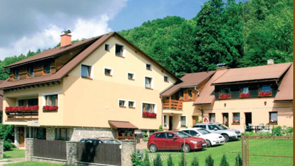 a couple of cars parked in front of a house at Chalupa Vaclav in Terchová