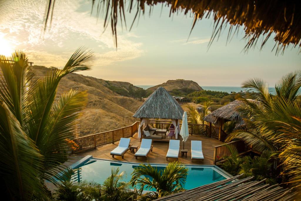 a villa with a swimming pool and a resort at Villa Del Sol in Máncora