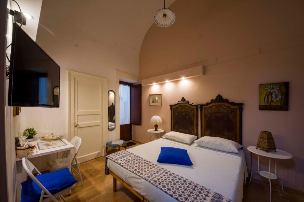 En eller flere senge i et værelse på Oasi al Duomo