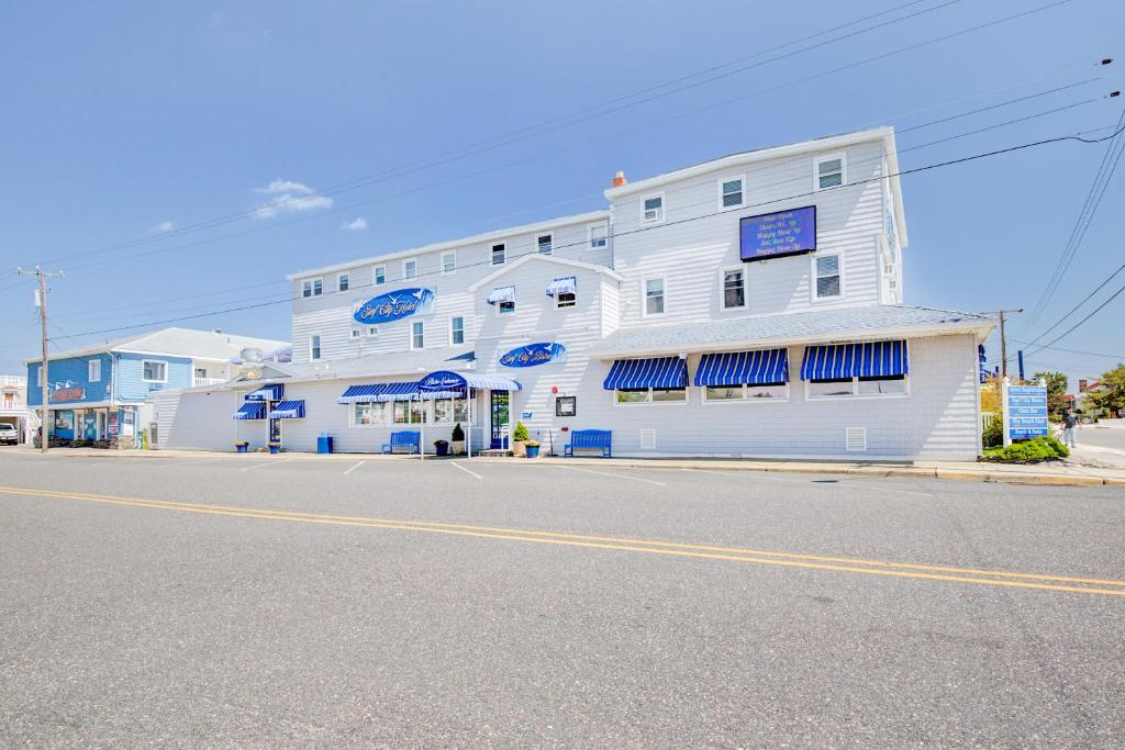 a large white building on the side of a street at Surf City Hotel in Surf City