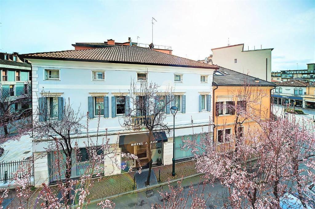 a large white building with trees in front of it at Hotel Aaron in Mestre