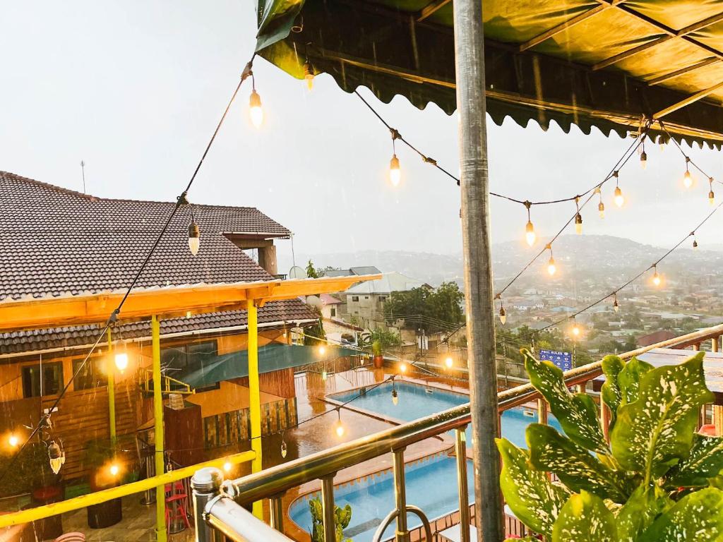 a view of a pool from the balcony of a hotel at Triple Hill Hotel in Weija