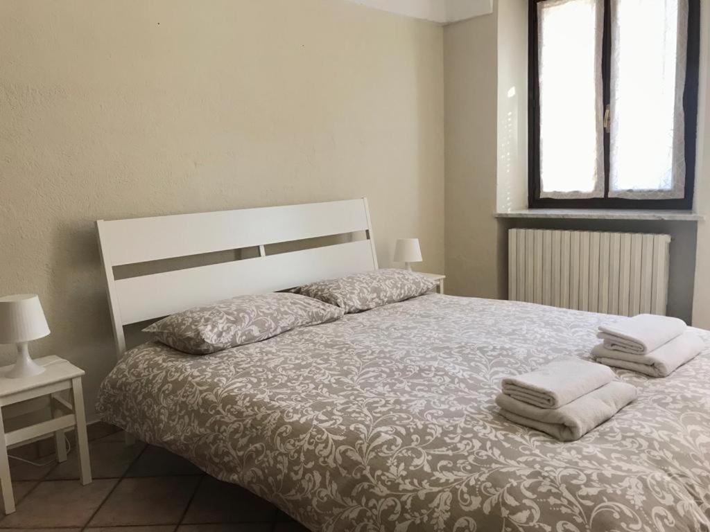1 dormitorio con 1 cama con toallas en Appartamento i Tulusan a due passi dalle Langhe, en Narzole