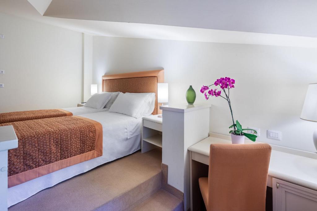 Postel nebo postele na pokoji v ubytování Park Hotel Olimpia