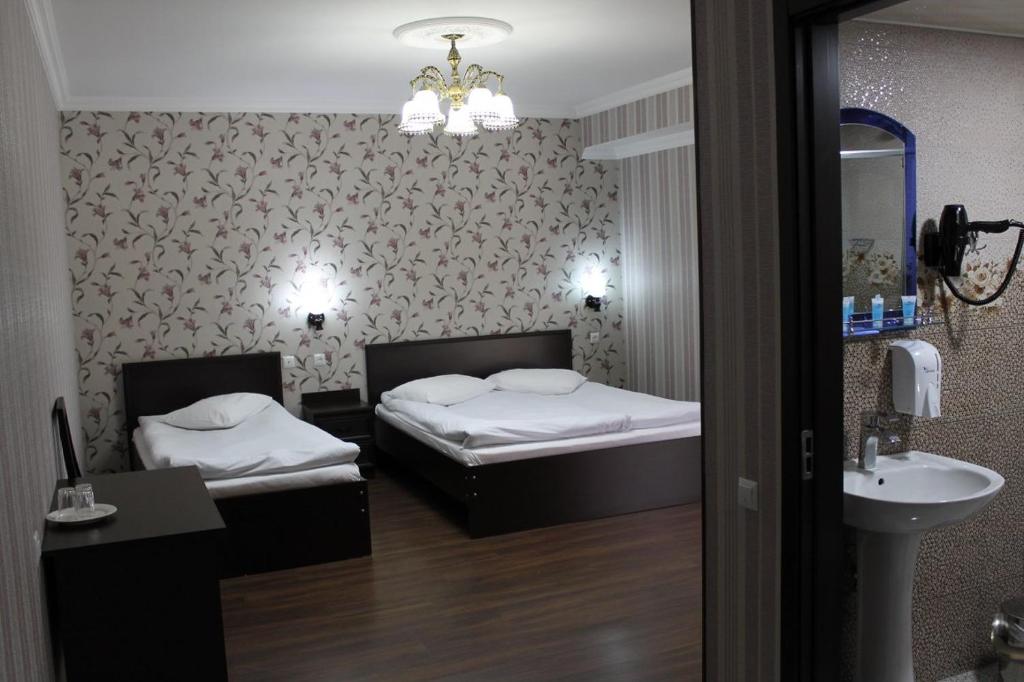 Postel nebo postele na pokoji v ubytování Hotel Grand Palace