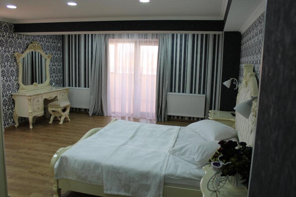 Postel nebo postele na pokoji v ubytování Hotel Grand Palace