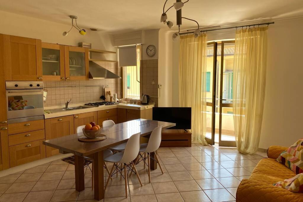 a kitchen and living room with a table and chairs at La Casa di Placido in Pescara