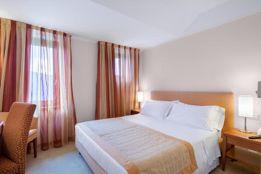 Postel nebo postele na pokoji v ubytování Park Hotel Olimpia