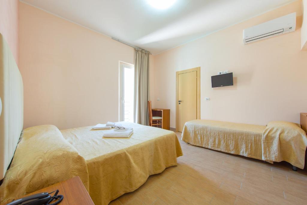 Postel nebo postele na pokoji v ubytování Hotel Adria Nuova