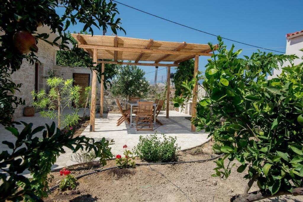 a wooden pergola with a table and chairs in a garden at Iris house Sivas (Ex. Sivas Villa 1) in Sívas