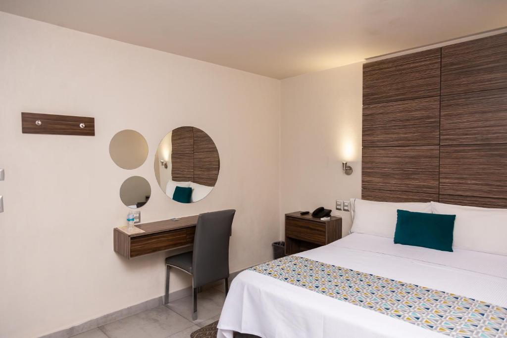 Postel nebo postele na pokoji v ubytování Hotel Expo Abastos
