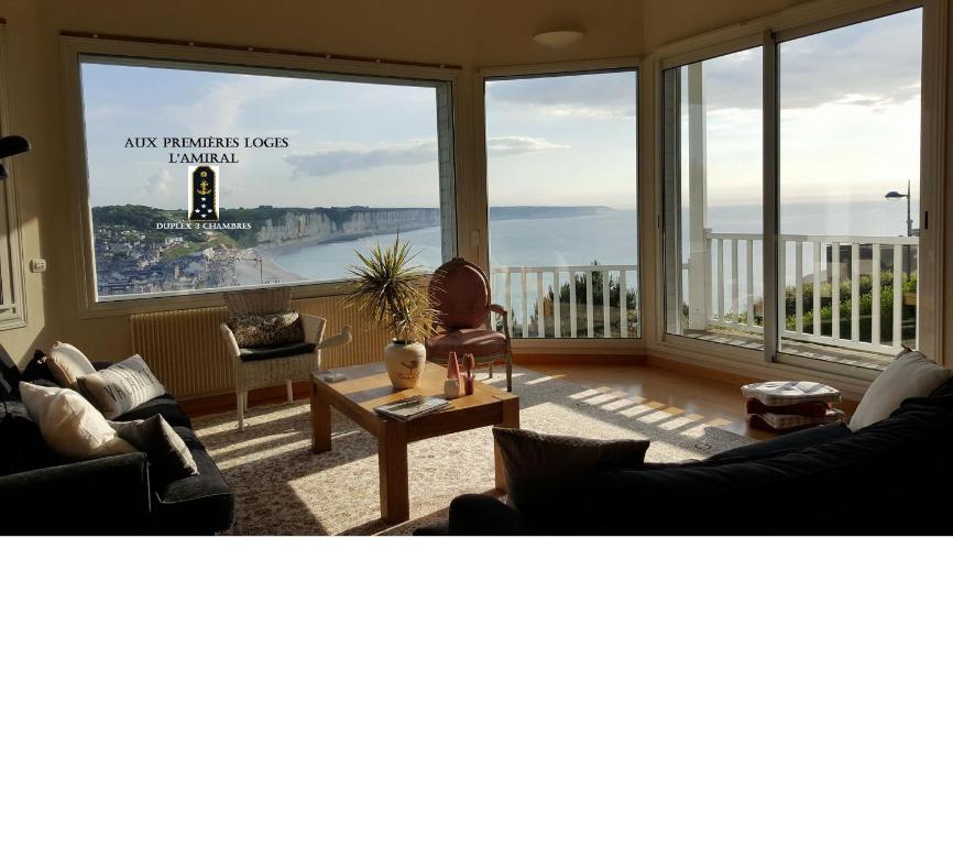 a living room with a view of the ocean at Aux Premières Loges in Fécamp