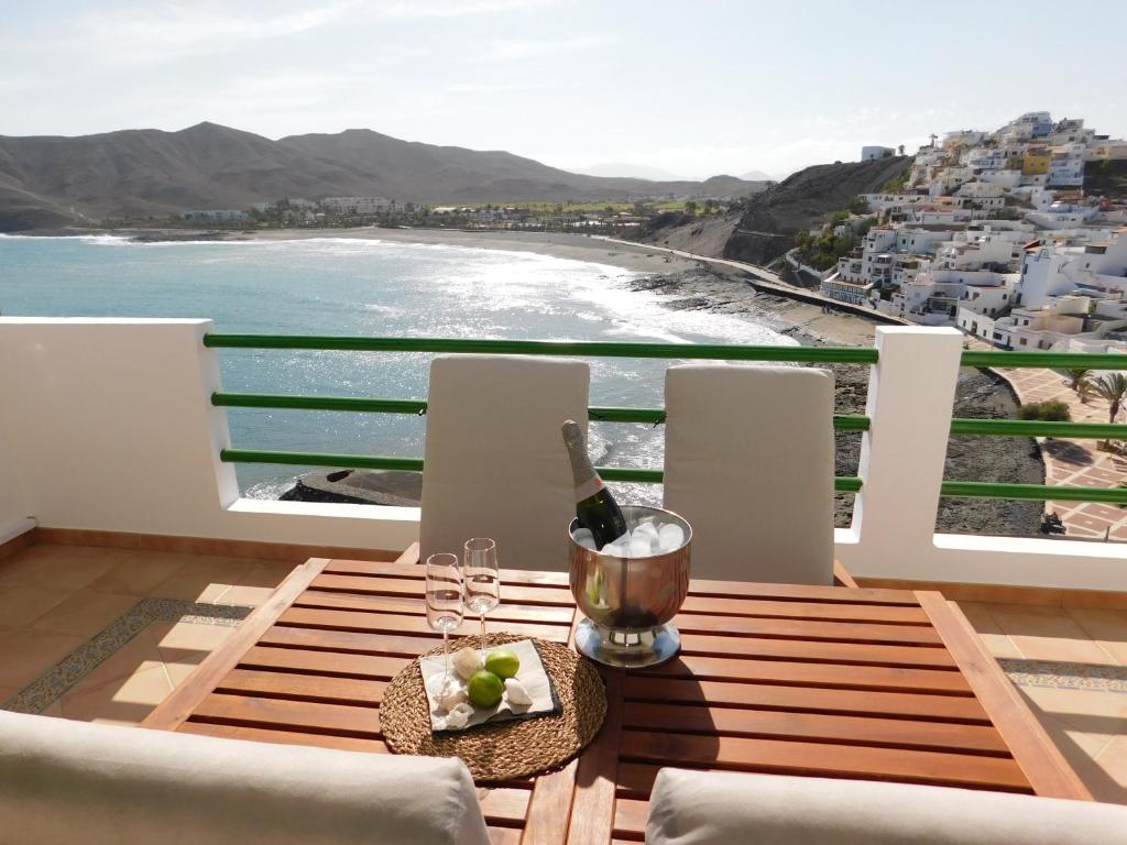 een tafel met een fles wijn en een bord eten bij Casa Marina in Las Playitas