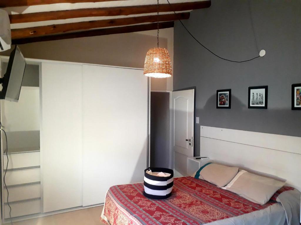 a bedroom with a bed and a chandelier at Departamento LUPANA in San Rafael
