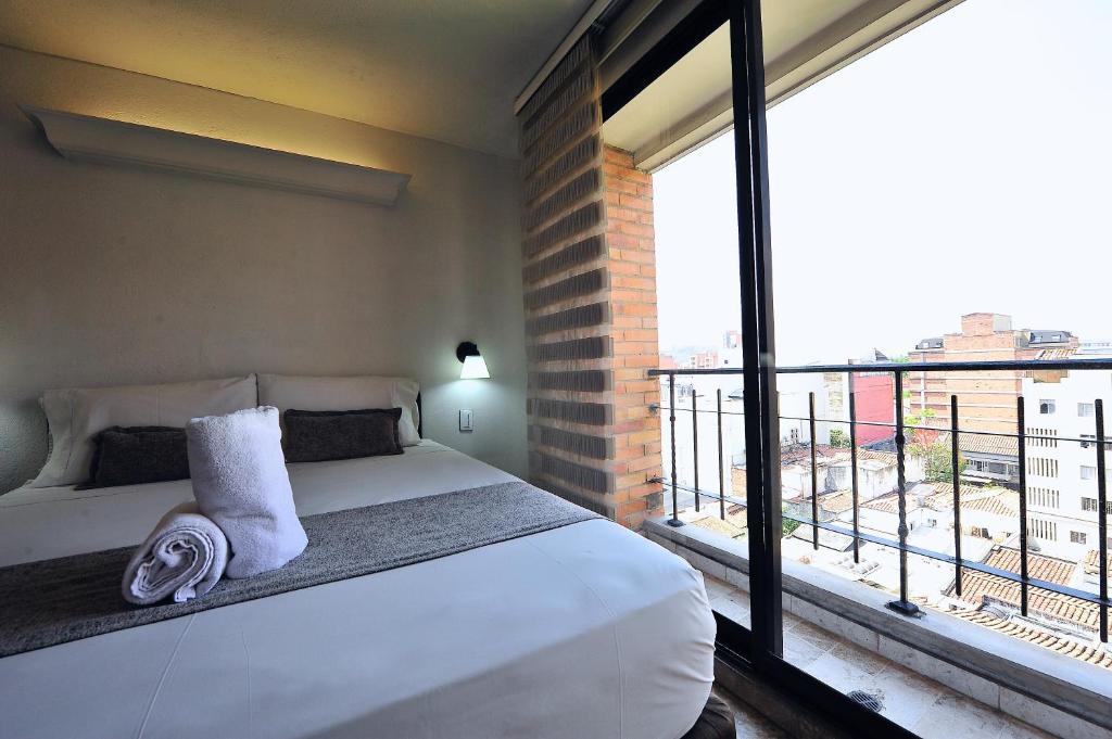 Postel nebo postele na pokoji v ubytování Hotel Cabo de la Vela Medellin
