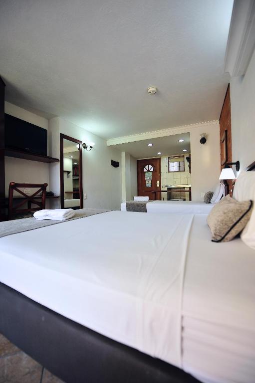 Postel nebo postele na pokoji v ubytování Hotel Cabo de la Vela Medellin