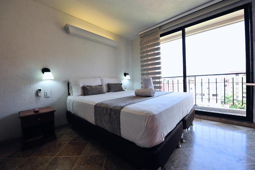 Postel nebo postele na pokoji v ubytování Hotel Cabo de la Vela Medellin