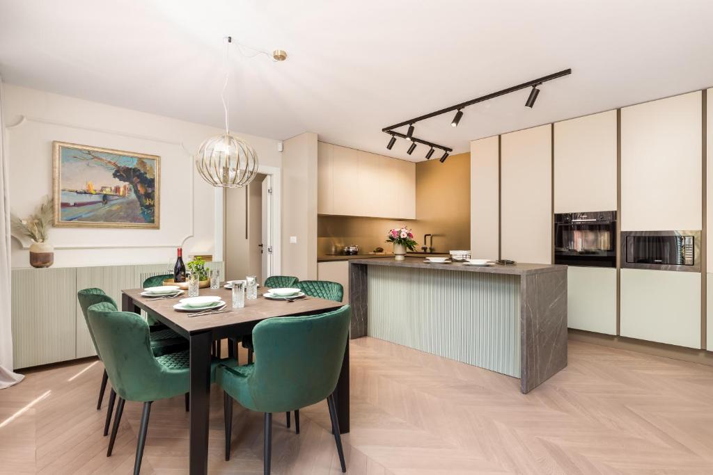 a kitchen and dining room with a table and chairs at Abau Residence Apartment- 50m to the sea in Opatija