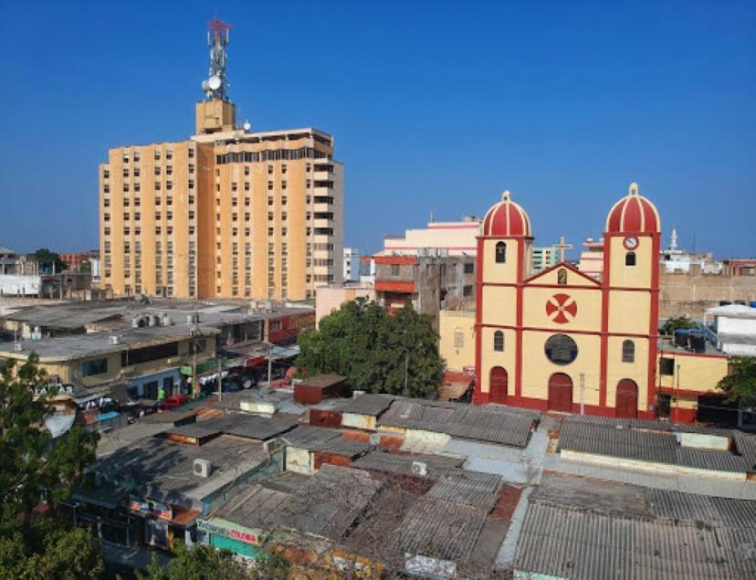 a building with two domes on top of a city at Maicao Internacional in Maicao