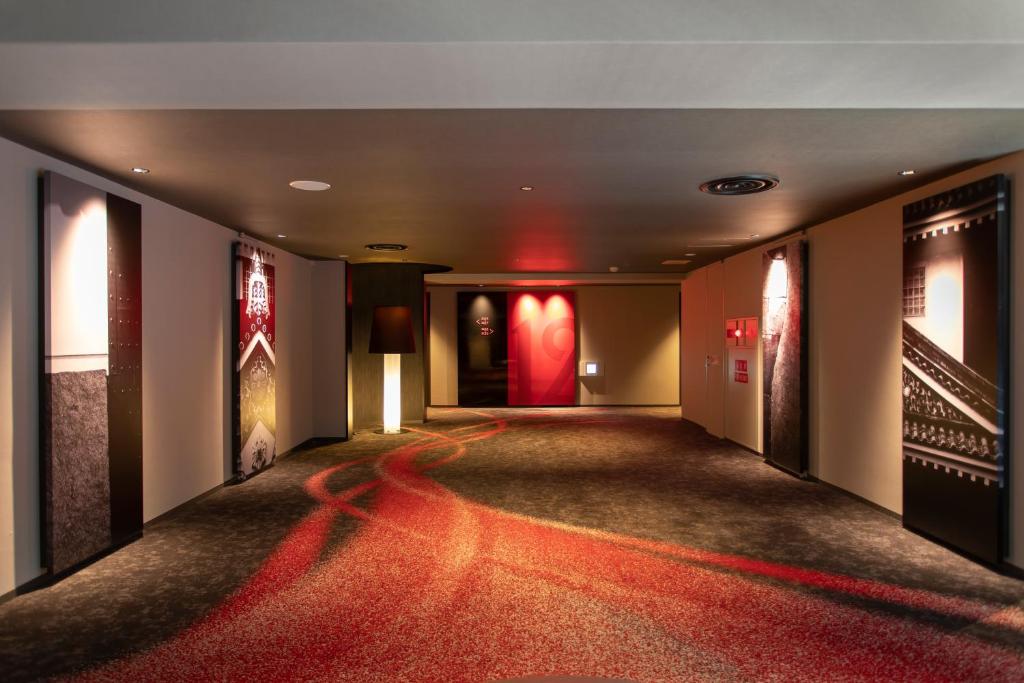 a hallway with a red carpet in a building at Cross Hotel Osaka in Osaka