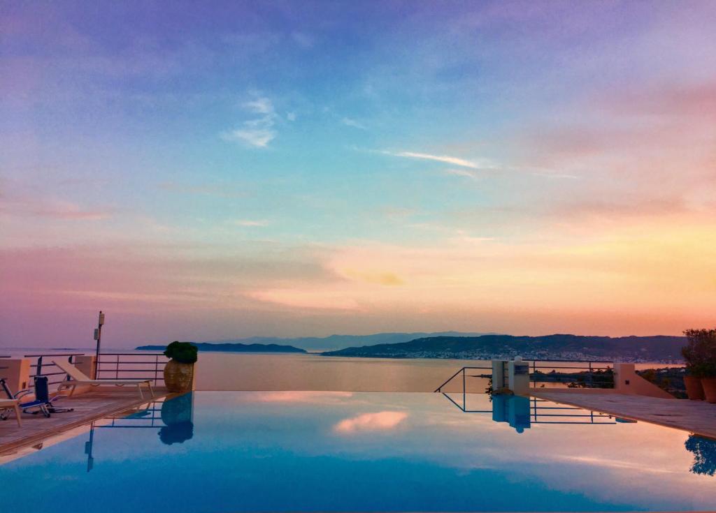 a swimming pool with a view of a body of water at Villa Thalia Floating Heaven in Porto Heli