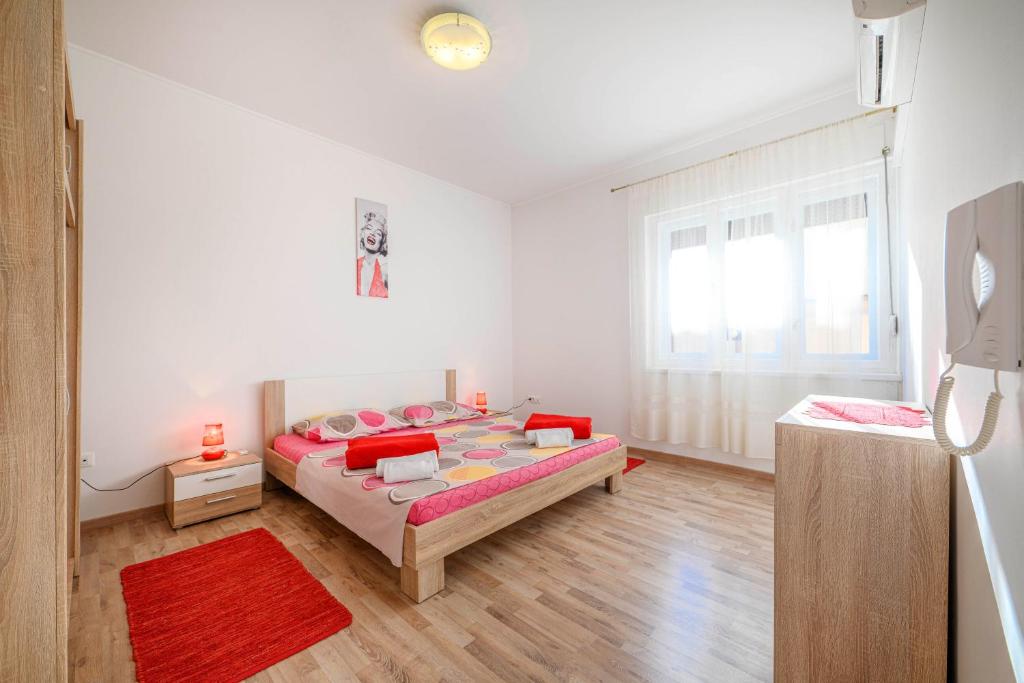 a bedroom with a bed and a large window at Urban City Center in Šibenik