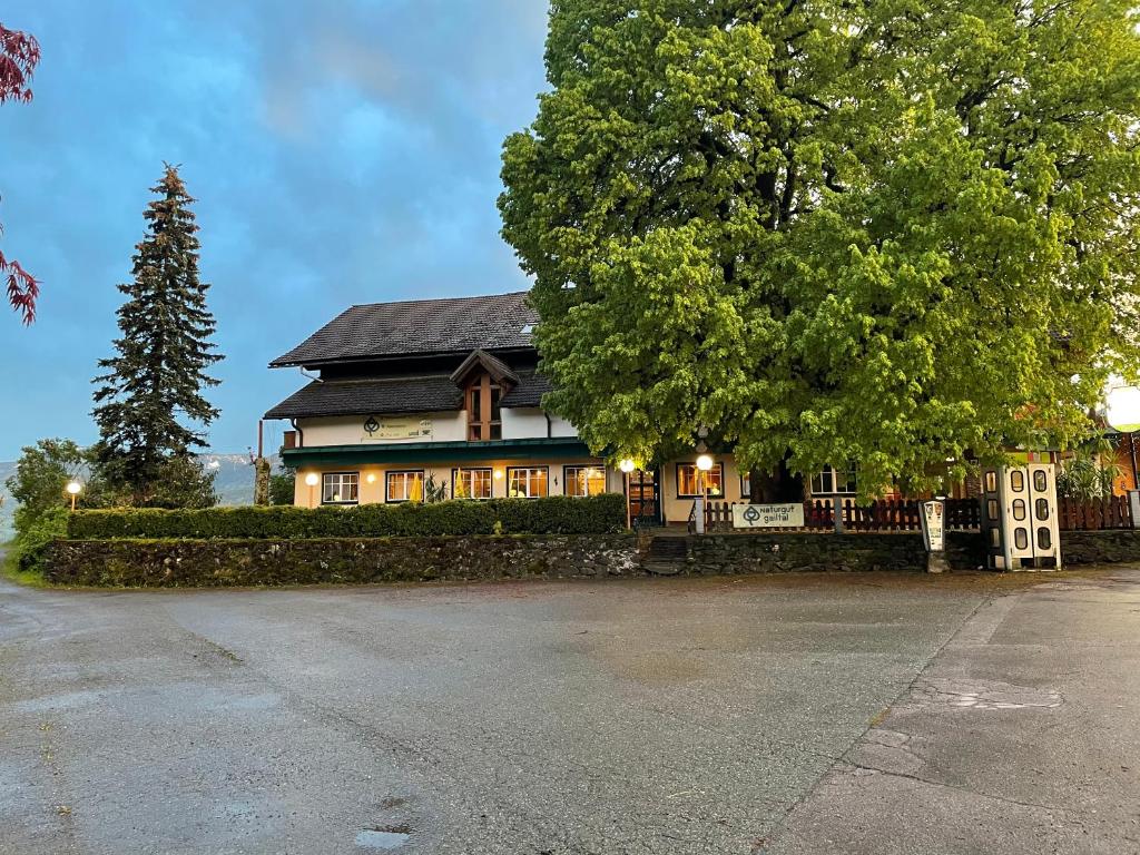 ein Haus mit einem Baum davor in der Unterkunft Naturgut Gailtal in Sankt Stefan an der Gail