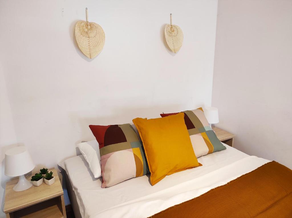 a bedroom with a bed with colorful pillows at Apartament Piaskowy NR A5 (3-5 os.) in Rowy