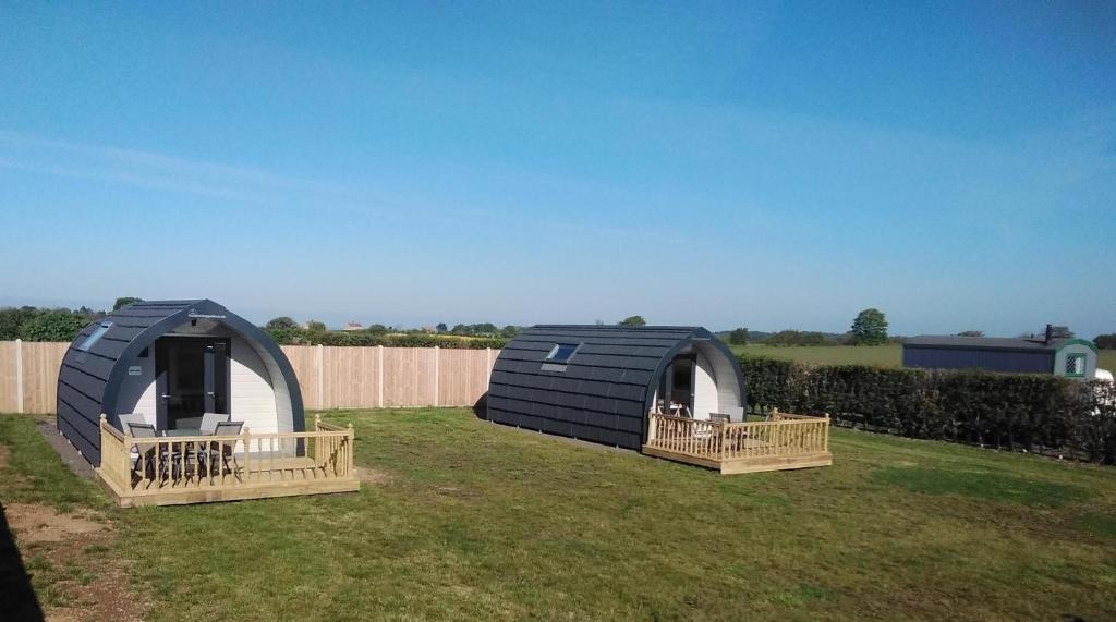 a couple of small tents in a yard at Glamping Pods in Cromer