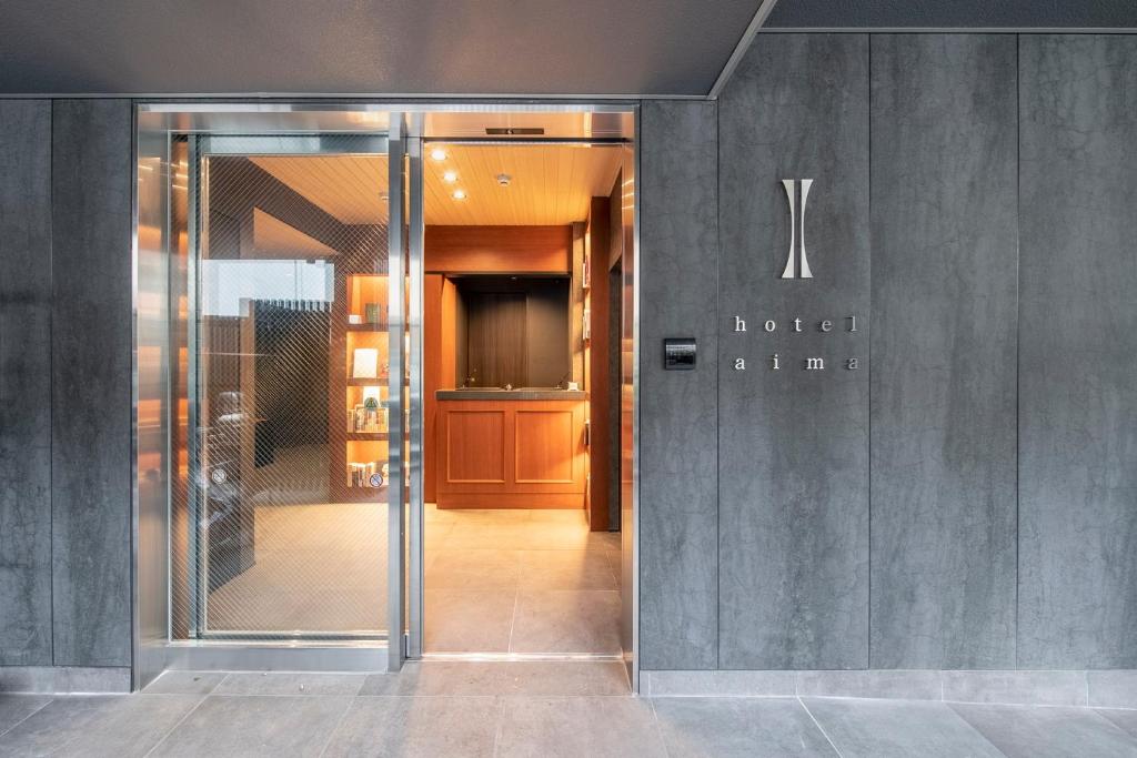 a lobby of a hotel entry with a glass door at hotel aima in Tokyo