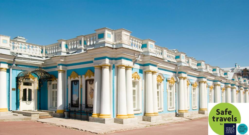 a large building with a blue and white building behind it at Ekaterina in Pushkin