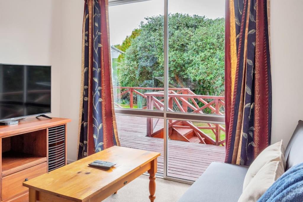 a living room with a couch and a large window at Little Self-Contained 1BR w Netflix - Parking in Auckland