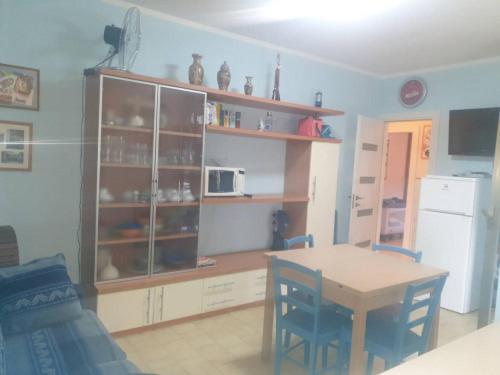 a kitchen with a table and a cabinet with a microwave at Casa Centurione Silvi Marina in Silvi Marina