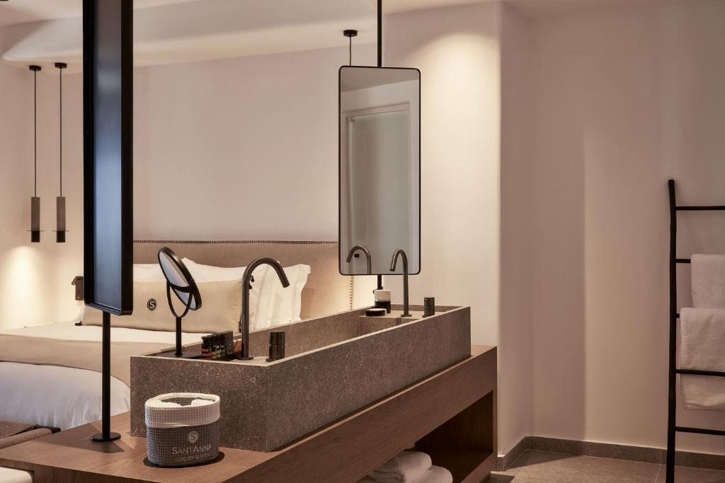 A bed or beds in a room at SantAnna Luxury Suites