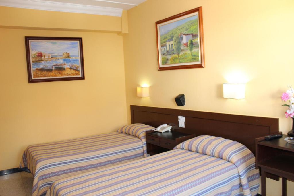 Posteľ alebo postele v izbe v ubytovaní Hotel Olympia