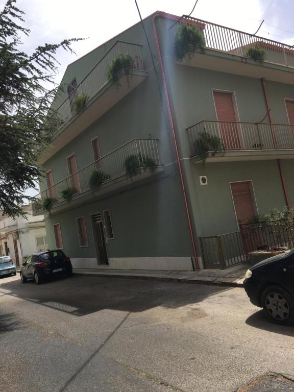 a building with potted plants on the side of it at Casa Baby Planet in Scicli