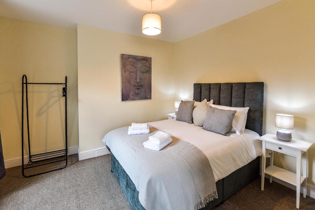 a bedroom with a large bed in a room at Guest Homes - Gerald House in Swansea