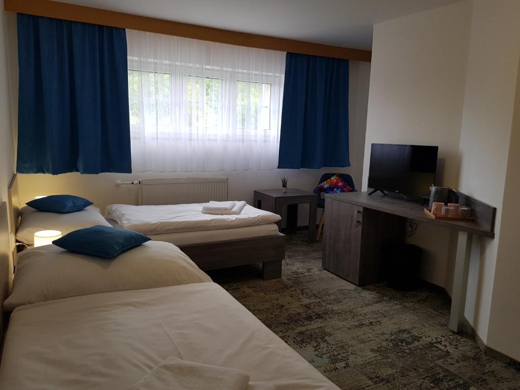 Postel nebo postele na pokoji v ubytování Penzion Vila Tereza
