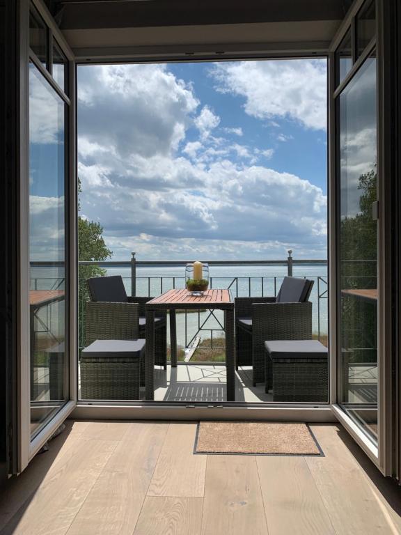 a balcony with a view of the ocean from a house at Eldenholz FeWo8 in Waren