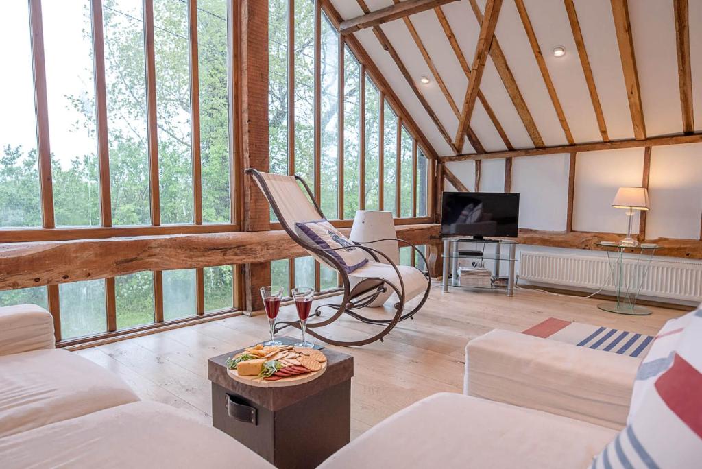 a living room with a couch and a chair at The Hayloft Clopton Air Manage Suffolk 