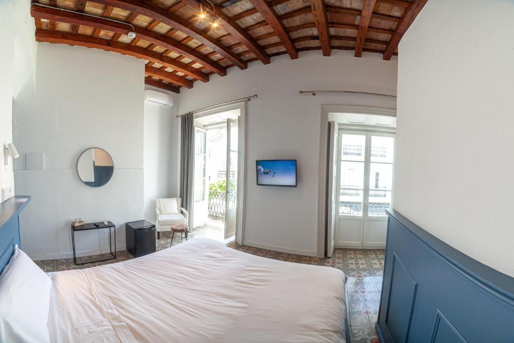 Postel nebo postele na pokoji v ubytování Apartahotel Siglo XIX