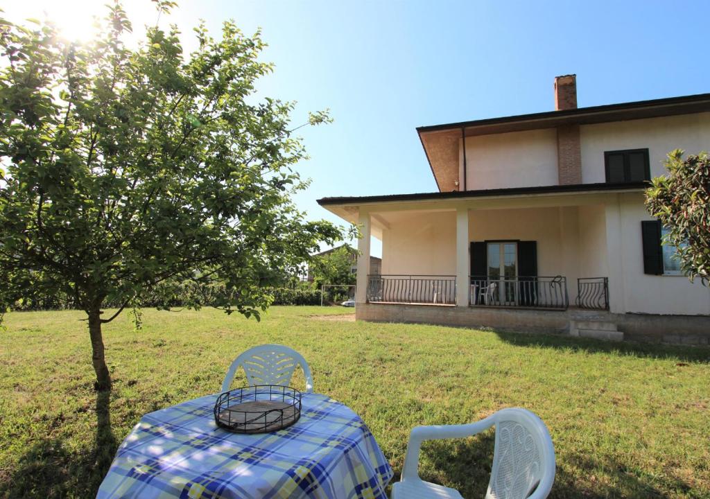 a table and chairs in front of a house at Villa Green - Irpinia in Venticano